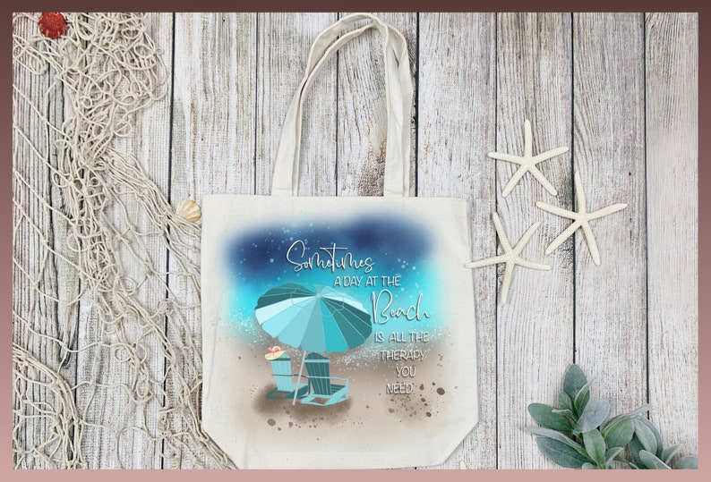 May include: A white canvas tote bag with a blue and green beach scene and the text "Sometimes a day at the beach is all the therapy you need".