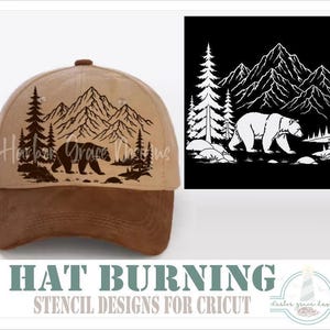 May include: A tan baseball cap with a dark brown brim featuring a black graphic of a bear walking in front of mountains and pine trees. The text Harbor Grace Designs is visible on the cap. A separate black square shows the same white graphic.