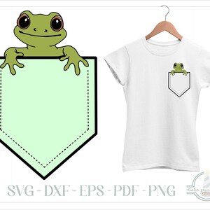 May include: A white t-shirt featuring a graphic of a green frog peeking out from a light green pocket. The design includes a large isolated graphic of the frog and pocket, along with the text SVG - DXF - EPS - PDF - PNG and Harbor Grace Designs.