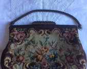 Vintage woolwork tapestry hand bag. Fabulous floral woolwork. Leather handle, leather covered metal frame, carved wooden clasp.