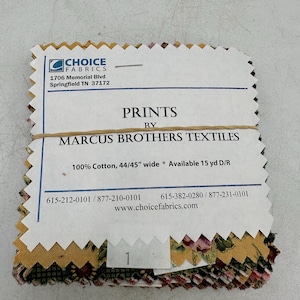 May include: A stack of fabric swatches with a floral pattern, held together with a brown band. The label reads "PRINTS BY MARCUS BROTHERS TEXTILES" and "100% Cotton, 44/45" wide". The Choice Fabrics logo is visible.