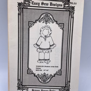 May include: A black and white illustration of a doll wearing a white hooded jacket and pants with fur trim. The doll is labeled "Eskimo" and is a "Toddler (Modern Artist Doll)". The illustration is from a sewing pattern for a 15-16 inch doll. The pattern is titled "Easy Sew Designs" and is from Brown House Dolls.