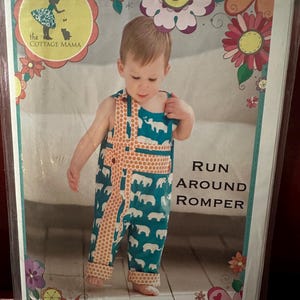 May include: A baby wearing a teal romper with white elephant patterns and orange trim. The romper has the text "RUN AROUND ROMPER" on the side. The packaging includes the logo "the COTTAGE MAMA" and floral designs.