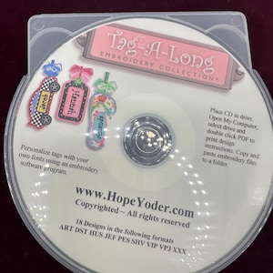 May include: A circular CD labeled Tag-A-Long Embroidery Collection featuring three embroidered tag examples, instructions for use, the website www.HopeYoder.com, and a list of 18 embroidery file formats including ART, DST, HUS, JEF, PES, SHV, VIP, VP3, and XXX.