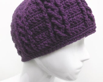May include: Purple crocheted beanie with a cable knit pattern.