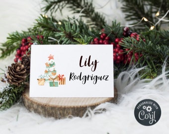 May include: A white Christmas card with a watercolor illustration of a Christmas tree with presents and the name "Lily Rodriguez" printed in black.