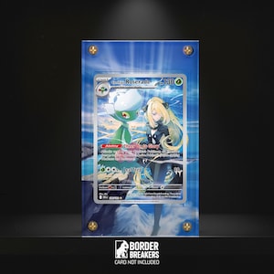 May include: A Pokémon trading card, Cynthia's Roserade, is displayed inside a clear acrylic case. The card features a green and white floral character and a blonde-haired woman. The case is secured with gold-colored screws. The Border Breakers logo is visible.