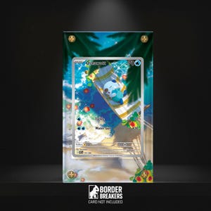 May include: A framed Pokémon trading card featuring Oshawott on a beach scene. The card is encased in a clear acrylic frame with gold-coloured corner accents. The background depicts a tropical beach with palm trees and ocean waves.