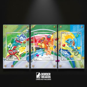 May include: Three clear display cases with Pokemon trading cards inside. Each case has a green and white border with gold-colored screws. The cards feature Bulbasaur, Charmander, and Squirtle. The Border Breakers logo is at the bottom.
