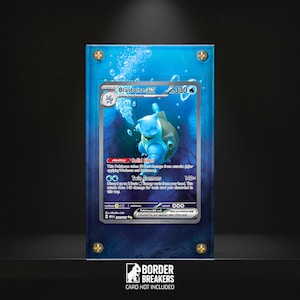 May include: A Blastoise EX Pokémon card displayed in a clear acrylic case with gold-colored screws. The card features a blue Blastoise illustration with the text "Blastoise EX" and "Twin Cannons". The case has a blue water-themed background.