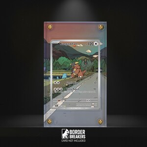 May include: A framed Kangaskhan Pokémon card with a colourful illustration of the character on a road. The card is encased in a clear acrylic holder with gold-coloured screws. The text "BORDER BREAKERS CARD NOT INCLUDED" is at the bottom.