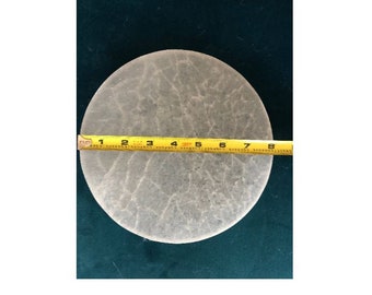 May include: A clear, round, glass plate with a textured surface. The plate is 8 inches in diameter and is measured with a yellow tape measure.