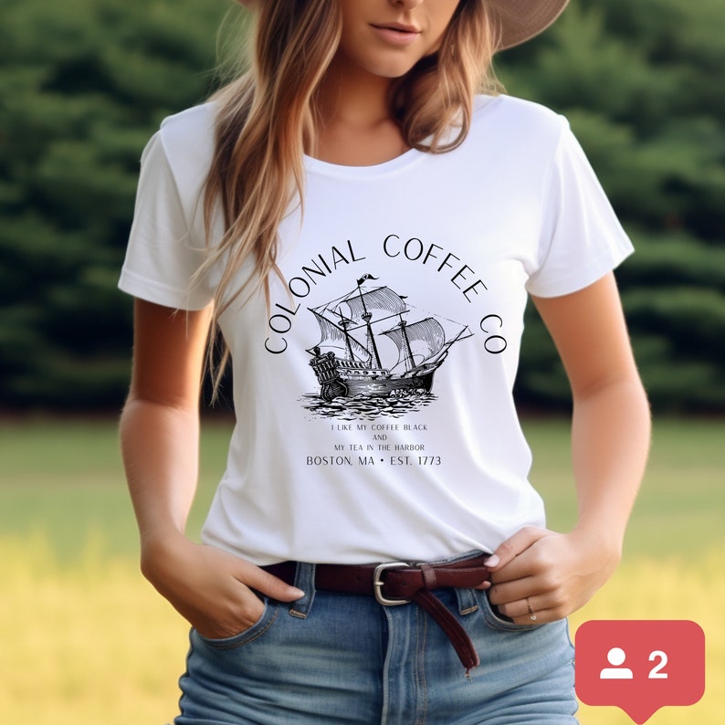 May include: White t-shirt with a black graphic of a sailing ship and the text "COLONIAL COFFEE CO." Below the ship is the text "I LIKE MY COFFEE BLACK AND MY TEA IN THE HARBOR BOSTON, MA &bull; EST. 1773."