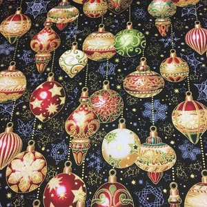 May include: A black fabric with a repeating pattern of gold, red, and green Christmas ornaments. The ornaments are decorated with gold and white swirls and have a 3D effect.
