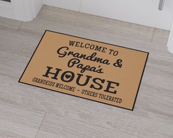 May include: A brown doormat with the text "Welcome to Grandma & Papa's House. Grandkids Welcome - Others Tolerated."