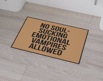 May include: A brown doormat with the text "NO SOUL-SUCKING EMOTIONAL VAMPIRES ALLOWED" printed in black.