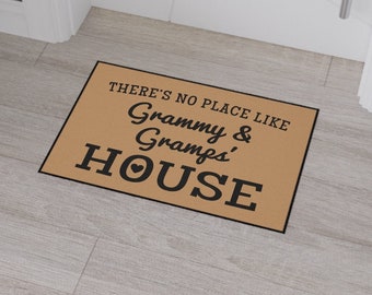 May include: A brown doormat with the text "There's no place like Granny & Gramps' House" in black lettering.