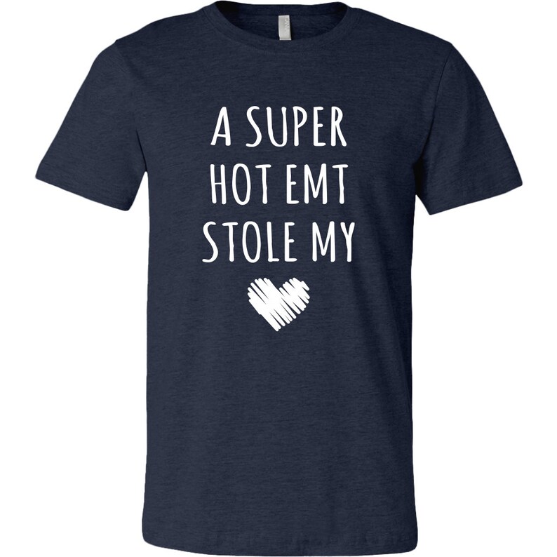 May include: A navy blue t-shirt with white text that reads "A super hot EMT stole my" with a white heart graphic below the text.