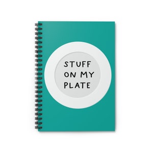 May include: Teal spiral bound notebook with a white circle and the text "STUFF ON MY PLATE" in black.