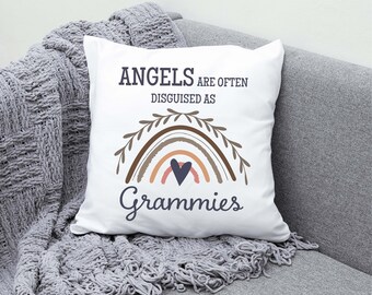 May include: White throw pillow with a rainbow design and the text "Angels are often disguised as Grammies".