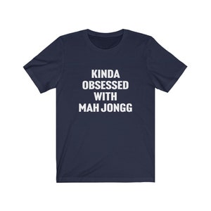 May include: A navy blue t-shirt with white text that reads "Kinda obsessed with Mah Jongg".