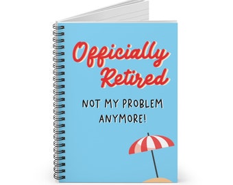 May include: A blue spiral notebook with the text "Officially Retired Not My Problem Anymore!" in red and black. A red and white beach umbrella is in the bottom right corner.