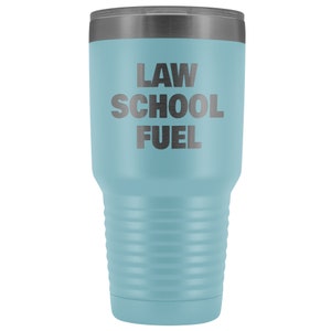 May include: A light blue stainless steel tumbler with a black lid and the text "LAW SCHOOL FUEL" printed on the side.