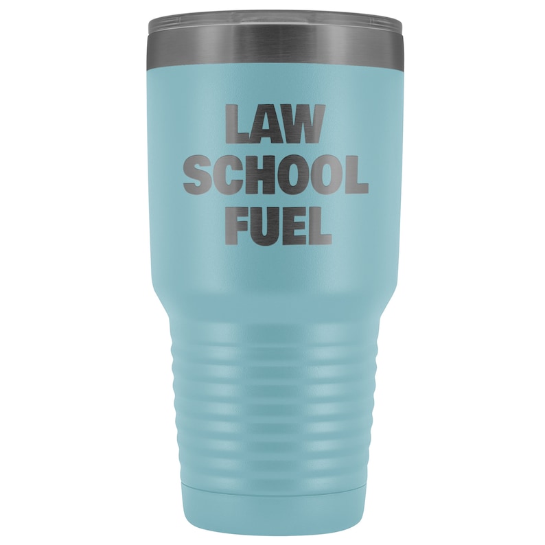 May include: A light blue stainless steel tumbler with a black lid and the text "LAW SCHOOL FUEL" printed on the side.