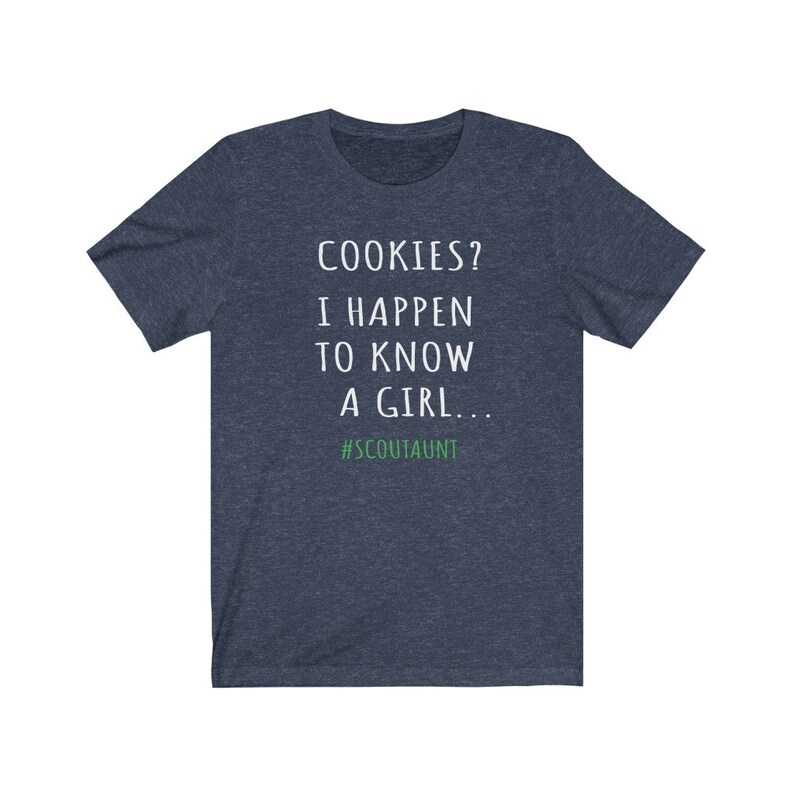 May include: A dark blue t-shirt with white text that reads "COOKIES? I HAPPEN TO KNOW A GIRL... #SCOUTAUNT".