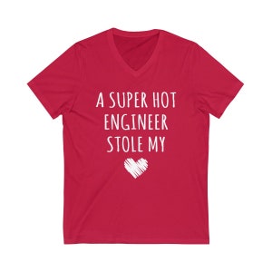 May include: Red V-neck t-shirt with white text that reads "A super hot engineer stole my" and a white heart.