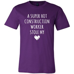 May include: Purple t-shirt with white text that reads "A super hot construction worker stole my heart".