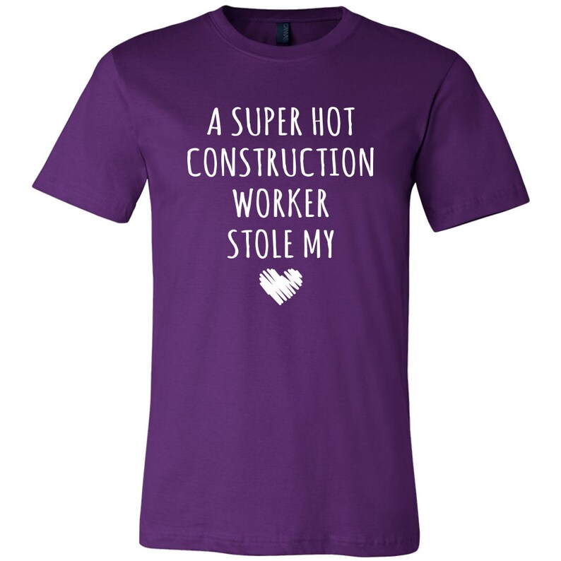 May include: Purple t-shirt with white text that reads "A super hot construction worker stole my heart".