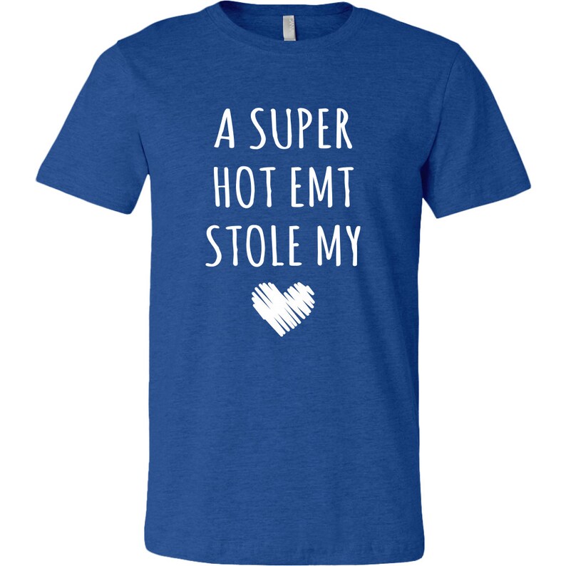 May include: A royal blue t-shirt with the text "A super hot EMT stole my" and a white heart graphic.