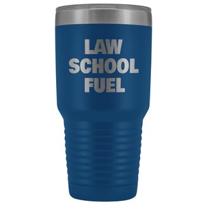 May include: A blue stainless steel tumbler with a silver lid. The tumbler has the text "LAW SCHOOL FUEL" printed on the side.