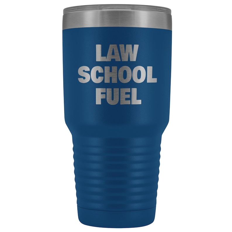 May include: A blue stainless steel tumbler with a silver lid. The tumbler has the text "LAW SCHOOL FUEL" printed on the side.