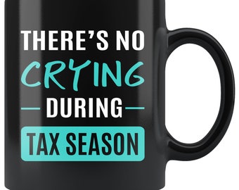 May include: Black coffee mug with white text that reads "There's no crying during tax season". The text "crying" is in teal blue.