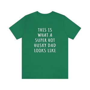 May include: Green t-shirt with white text that reads "This is what a super hot husky dad looks like."