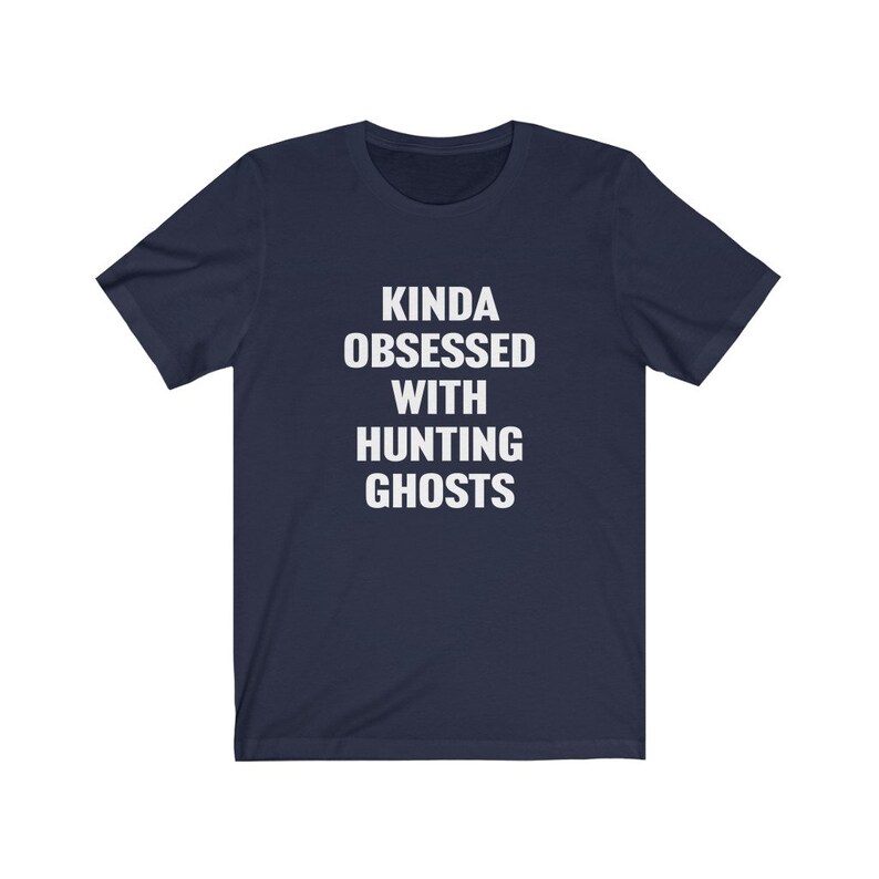May include: A navy blue t-shirt with white text that reads "Kinda obsessed with hunting ghosts".