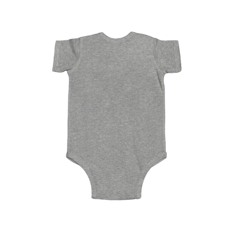 May include: A gray short-sleeved baby onesie with a snap closure.