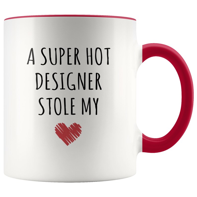 May include: White ceramic mug with a red interior and handle. The mug features the text "A SUPER HOT DESIGNER STOLE MY" in black, with a red heart graphic below the text. A fun gift idea.