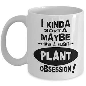 May include: White ceramic mug with a black text that reads "I kinda sorta maybe have a slight plant obsession!" The mug has a curved handle and a cylindrical shape, perfect for coffee or tea.