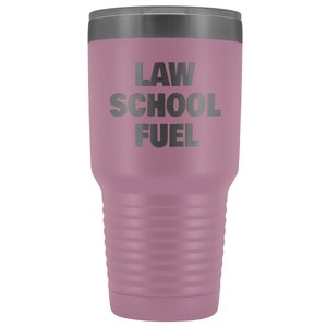 May include: A mauve stainless steel tumbler with a black lid and the text "LAW SCHOOL FUEL" printed on the side.