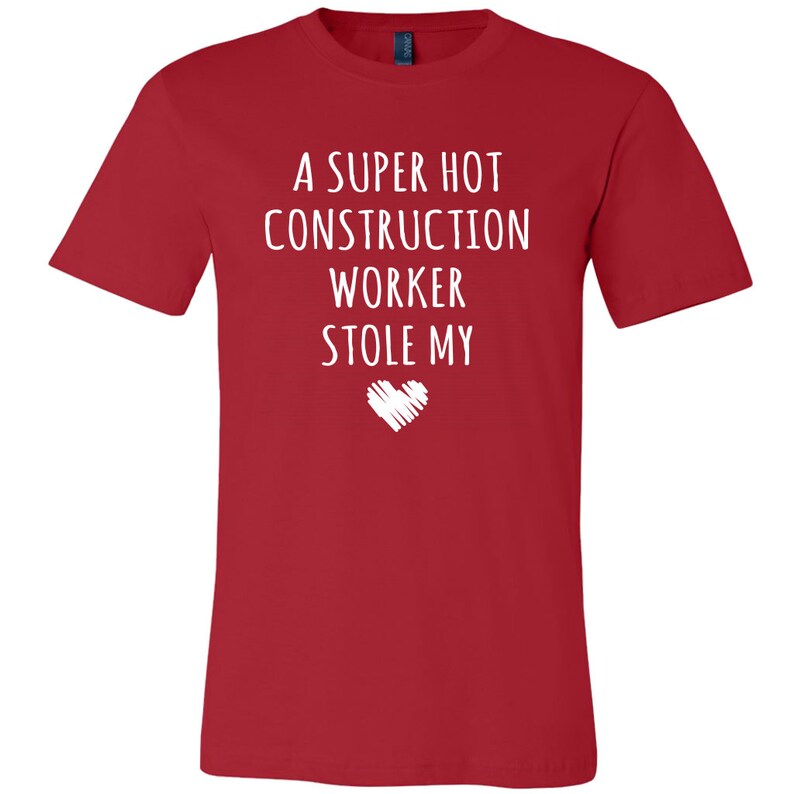 May include: Red t-shirt with white text that reads "A super hot construction worker stole my heart".