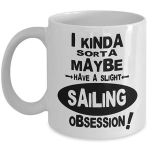 May include: White ceramic coffee mug with black text that reads "I kinda sorta maybe have a slight sailing obsession!"