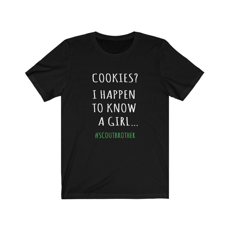 May include: Black t-shirt with white text that reads "COOKIES? I HAPPEN TO KNOW A GIRL... #SCOUTBROTHER".