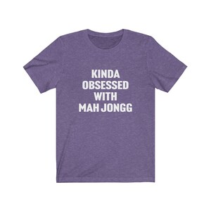 May include: Purple t-shirt with white text that reads "Kinda obsessed with Mah Jongg".
