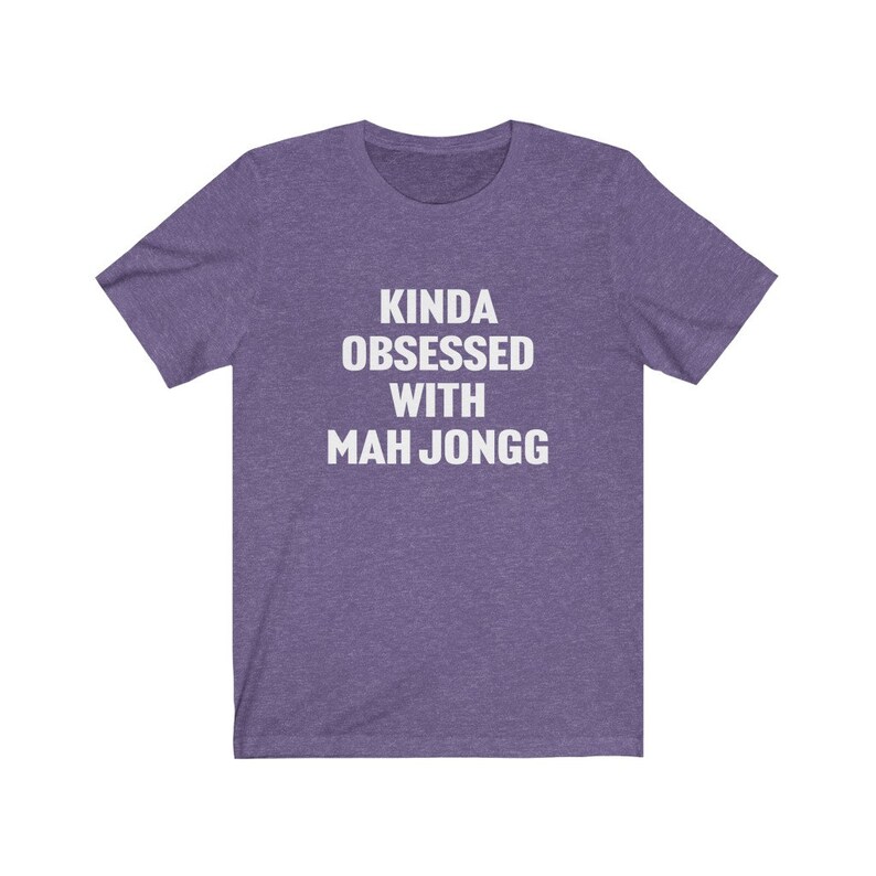 May include: Purple t-shirt with white text that reads "Kinda obsessed with Mah Jongg".