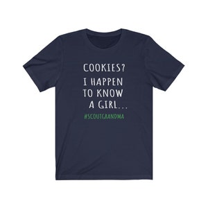 Puede incluir: Camiseta azul marino con texto blanco que dice "COOKIES? I HAPPEN TO KNOW A GIRL... #SCOUTGRANDMA".