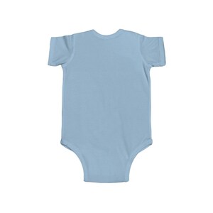 May include: A light blue baby onesie with short sleeves.