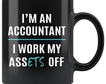 May include: Black coffee mug with white text that reads "I'm an accountant I work my assets off". The word "assets" is highlighted in turquoise.